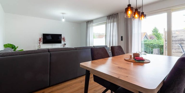 Große Fensterfronten bringen viel Tageslicht in den großzügigen Wohn- und Essbereich.